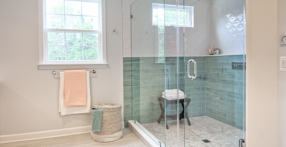 large bathroom with floor to ceiling glass shower doors and a large window in the shower looking out the the yard